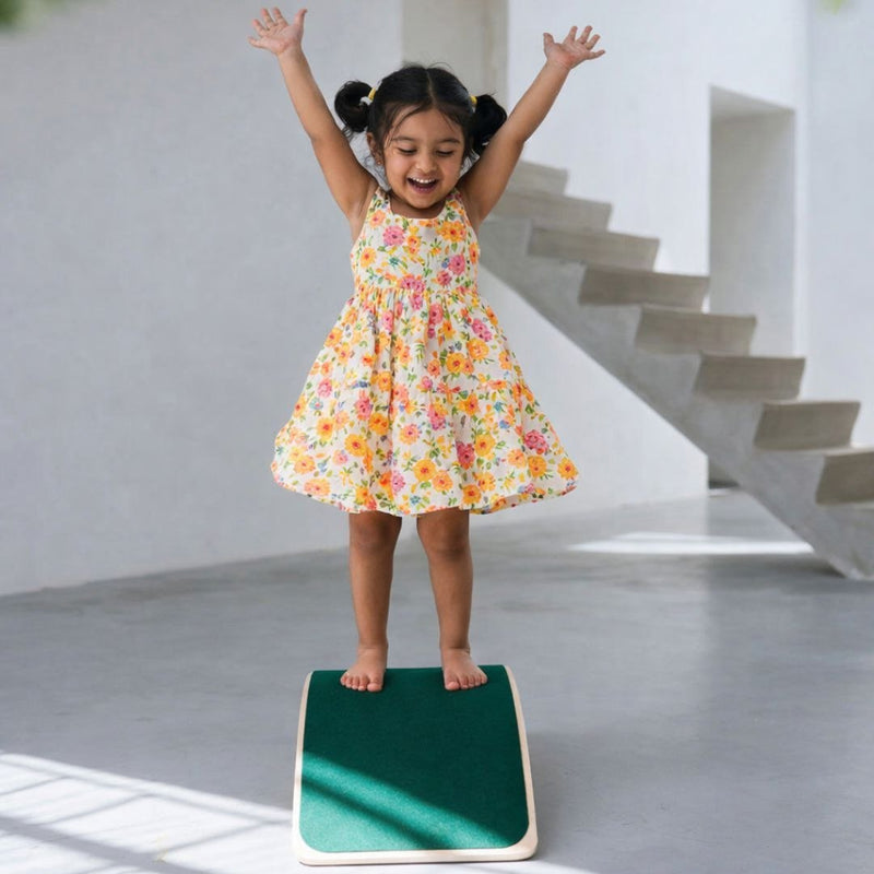 Wooden balance board with non-slip green textured surface for kids